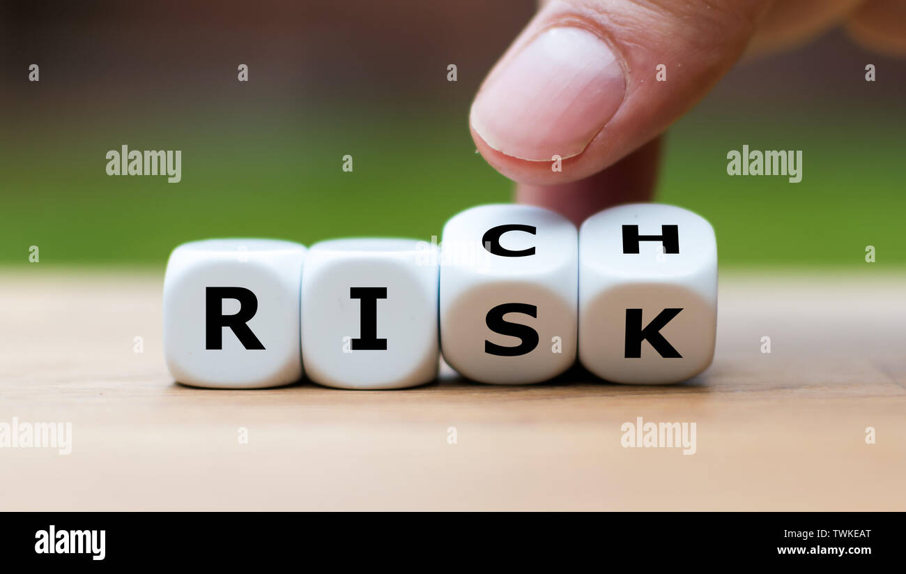 Take a risk and getting rich concept. Hand turns dice and changes the