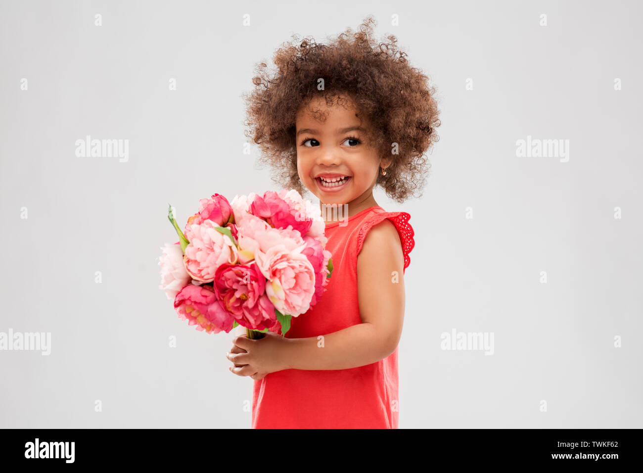 happy little african american girl with flowers Stock Photo - Alamy