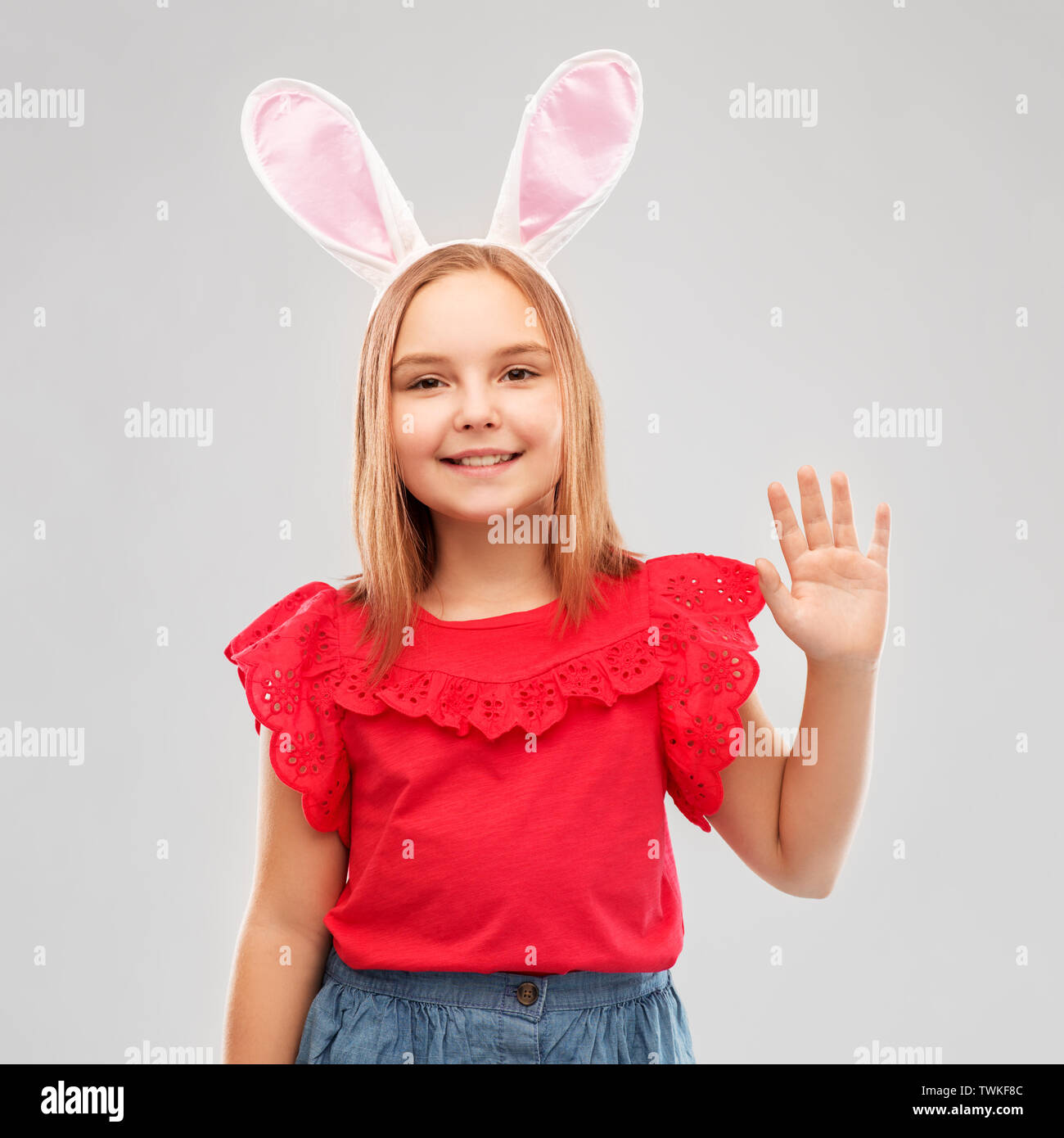 happy girl wearing easter bunny ears waving hand Stock Photo Alamy