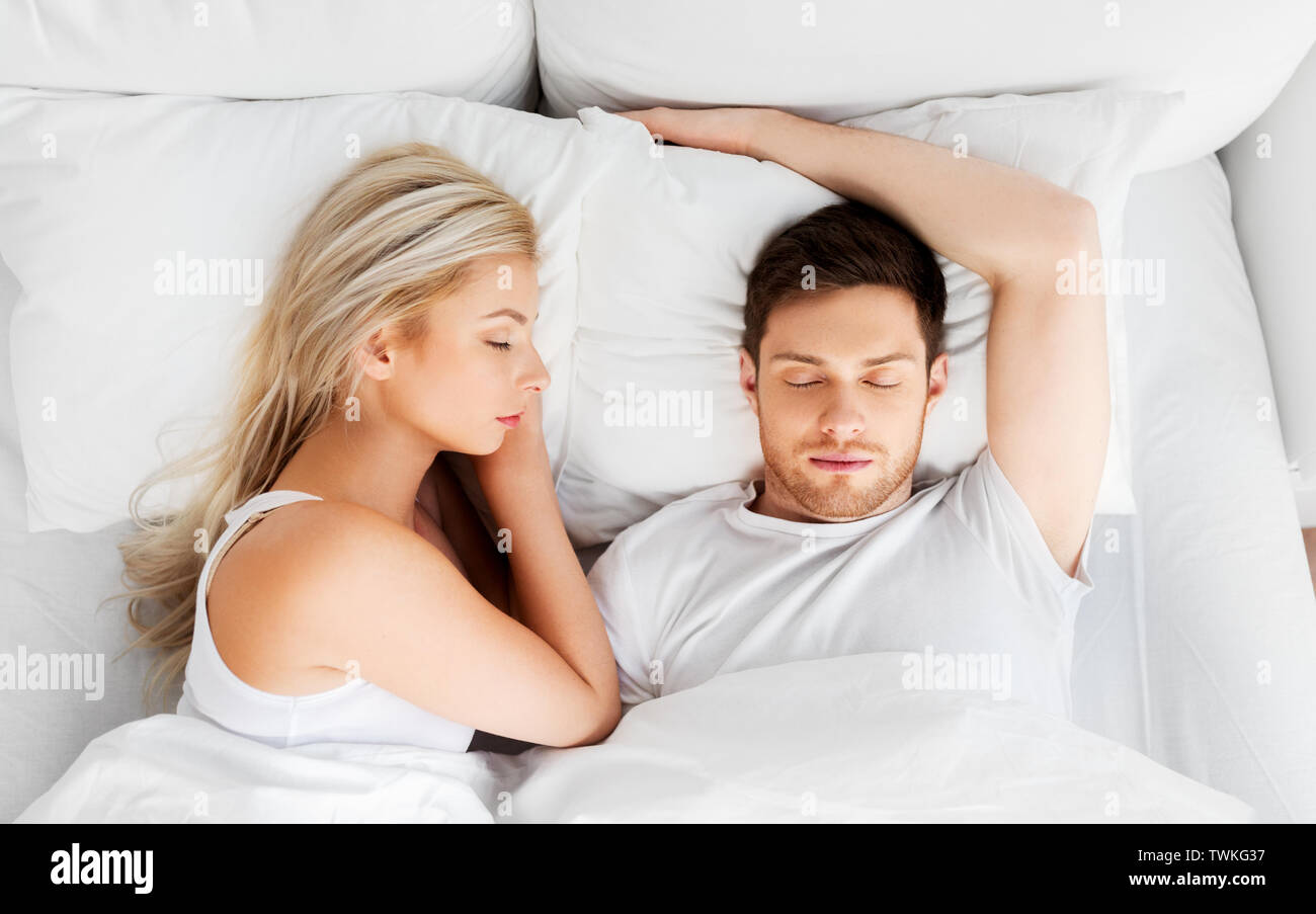 happy couple sleeping in bed at home Stock Photo - Alamy