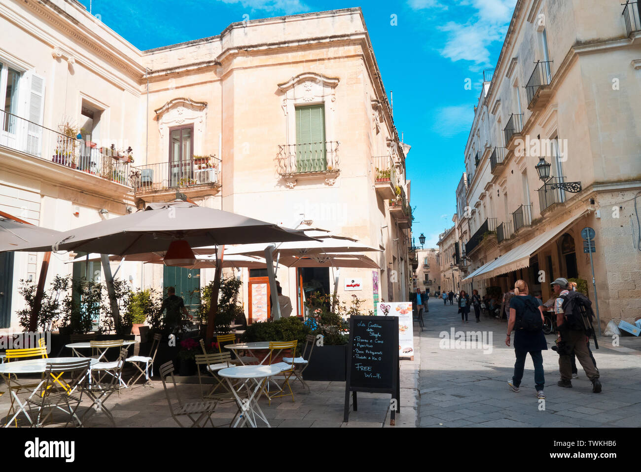 Lecce,Italy,10/10/2016; two travelers with the bags on their shoulder in the street of Lecce,who walk fast and speak in a beautiful autumn morning Stock Photo