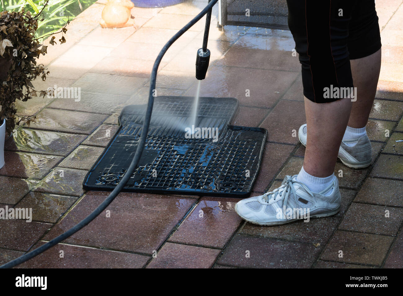 Close up cleaning of car mat with a pressure washer Stock Photo Alamy
