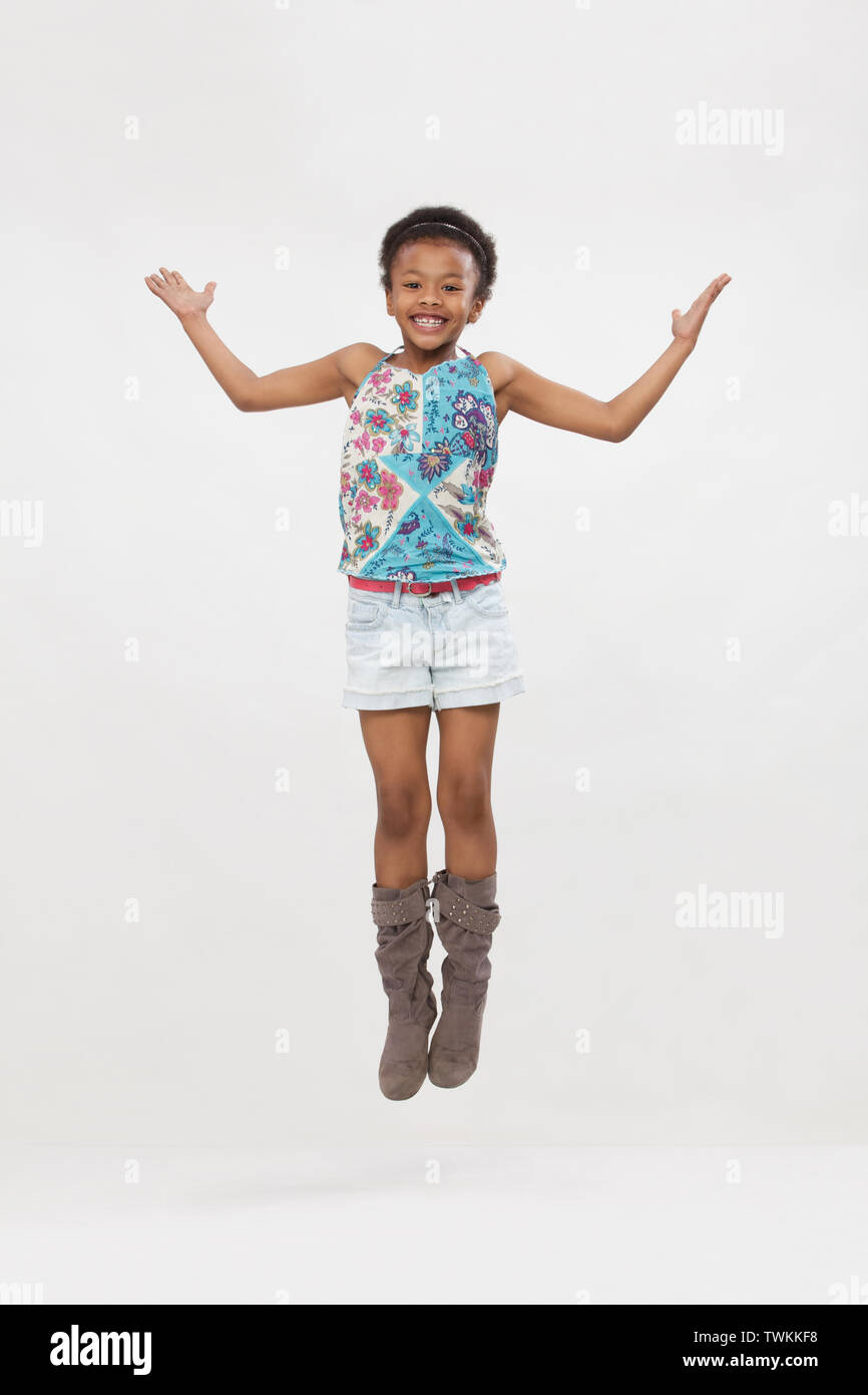 Girl jumping in air and smiling Stock Photo - Alamy