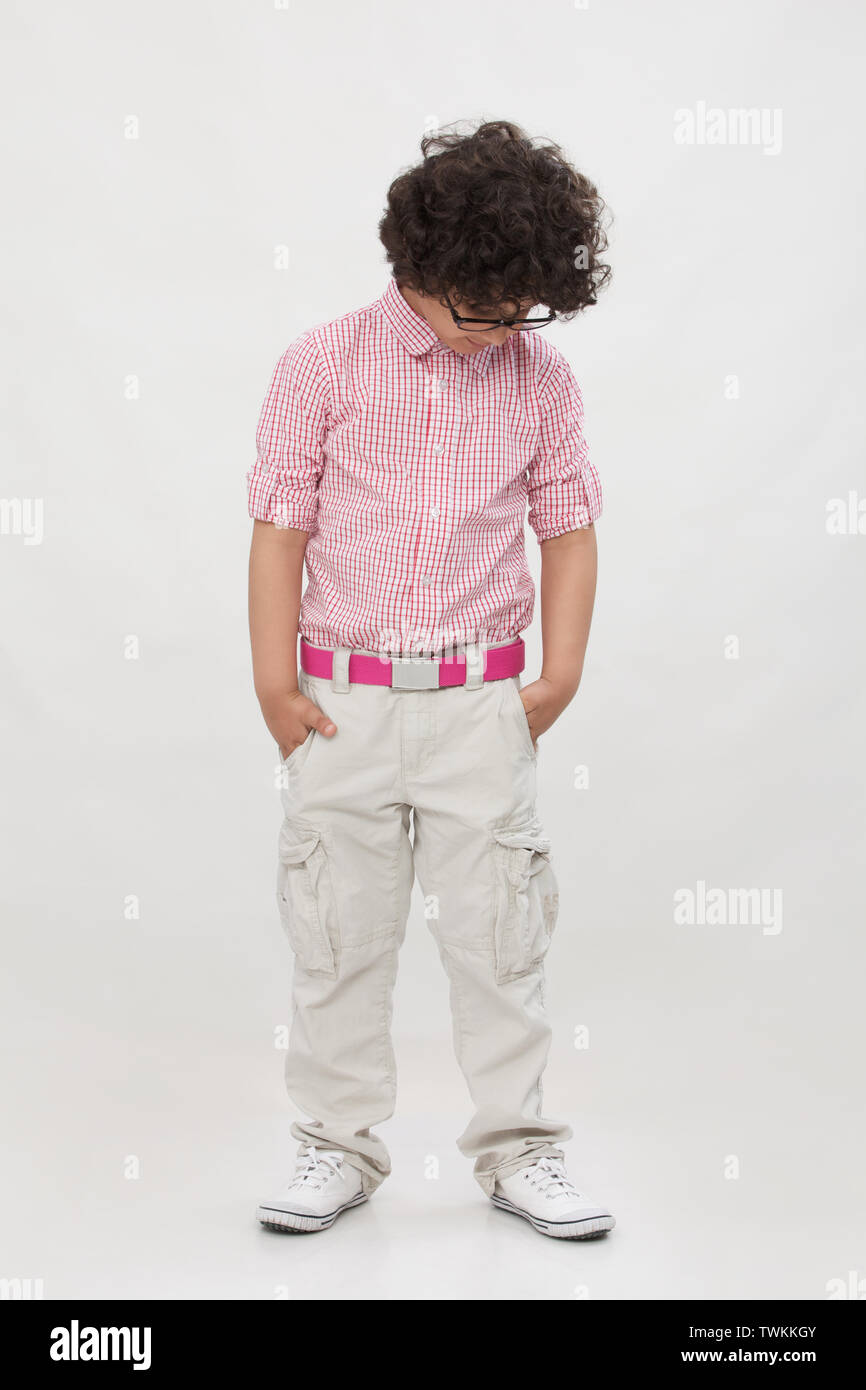 Boy standing with his hands in pockets Stock Photo Alamy