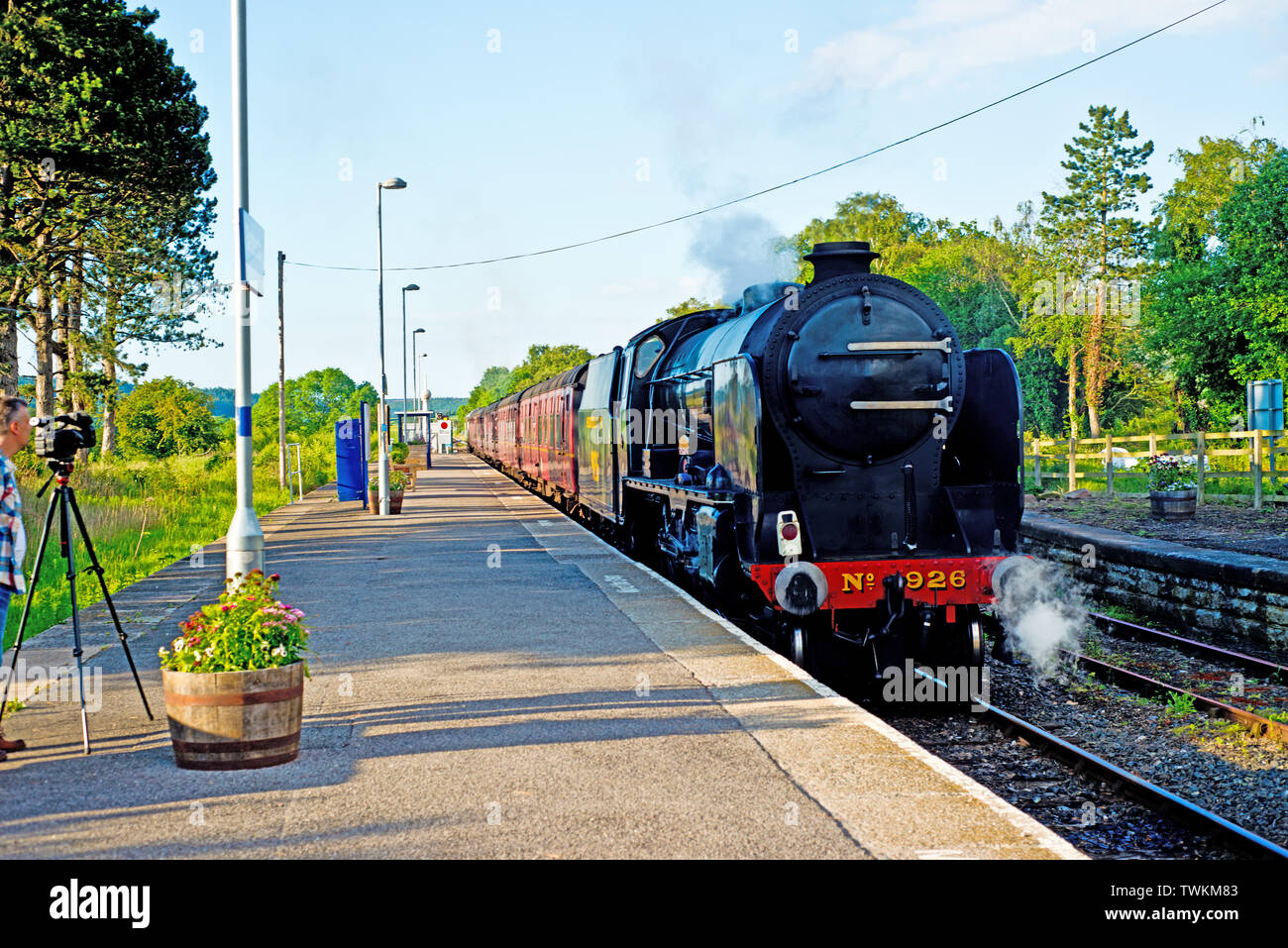 Videographer filming Shools Class no 926 Repton coming into Battesby Junction Station North Yorkshire, 19th June 2019 Stock Photo