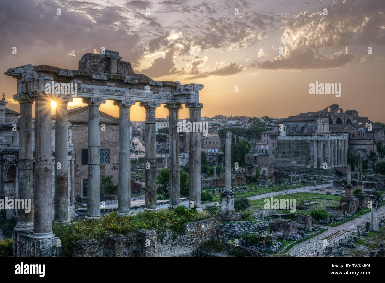 Rome. View of the Imperial Forums with the sun rising between the ancient columns. Stock Photo