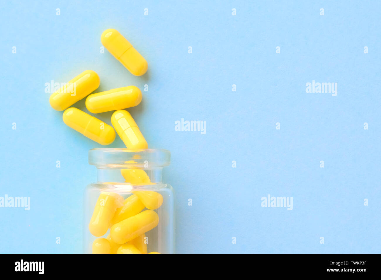 Yellow Capsules From Glass Bottle On Blue Background Copyspace For Text Epidemic Painkillers Healthcare Treatment Pills And Drug Abuse Concept Stock Photo Alamy
