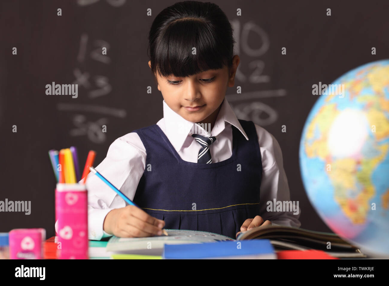 Schoolgirl studying in a classroom Stock Photo - Alamy