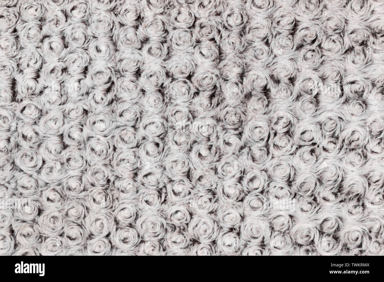 Background and texture of grey artificial fur with round curls. Close-up Stock Photo