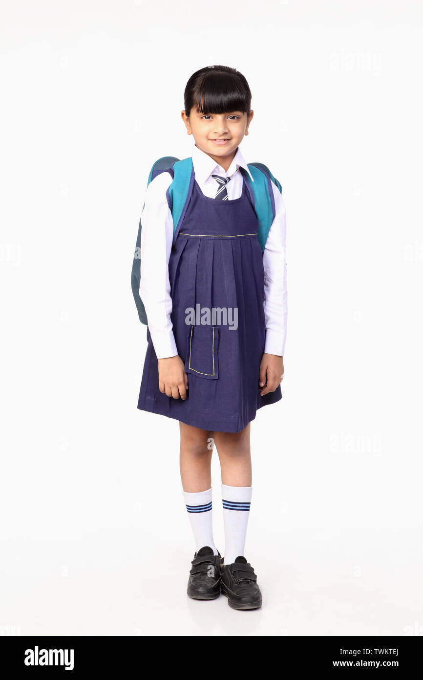 Schoolgirl with a book bag smiling Stock Photo - Alamy