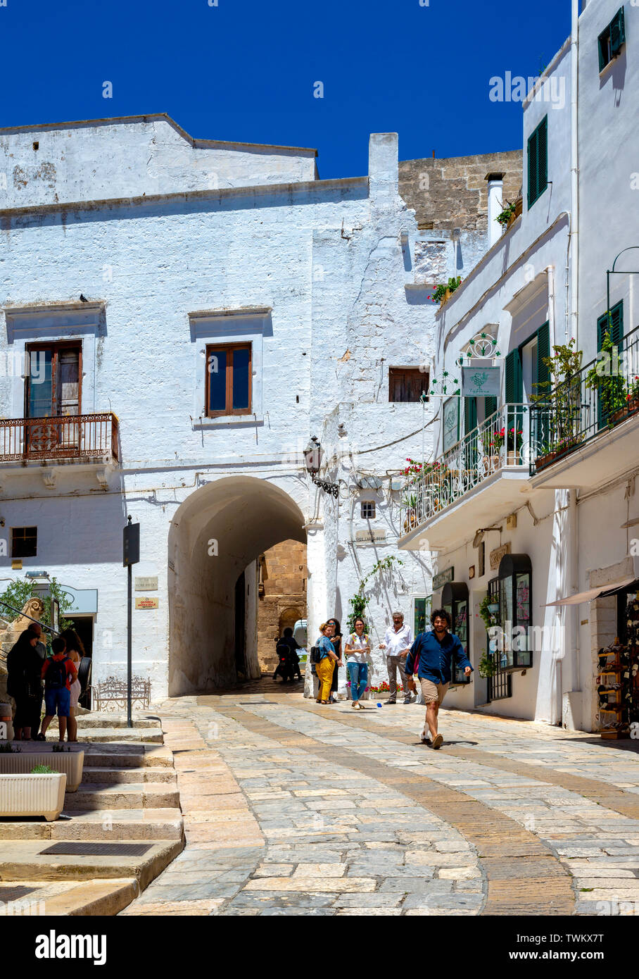 Ostuni, Italy - 24 June 2018: tourists in the characteristic streets of the historic center of Ostuni. Stock Photo