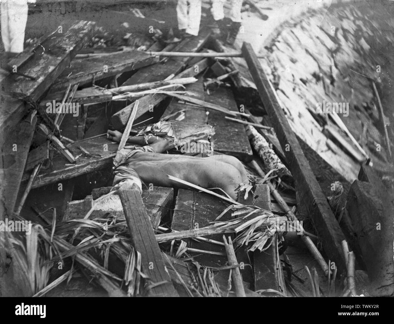 A body amongst the wreckage in the aftermath of the 1906 Hong Kong typhoon, 18 September 1906. Up to 10,000 people lost their lives with exception damage caused across the harbour and shorelines in the British Crown Colony. Photo by Tony Henshaw Stock Photo