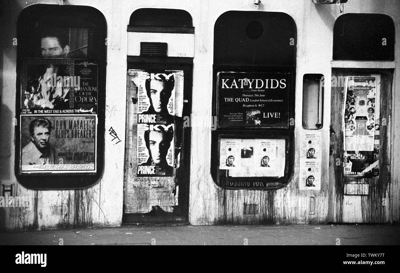 A run down street, London c1987 with fly posters for musicians and events including John Mayall, The Phantom Of The Opera, Sky Magazine, Prince, Katydids, Soul II Soul. Photo by Tony Henshaw Stock Photo