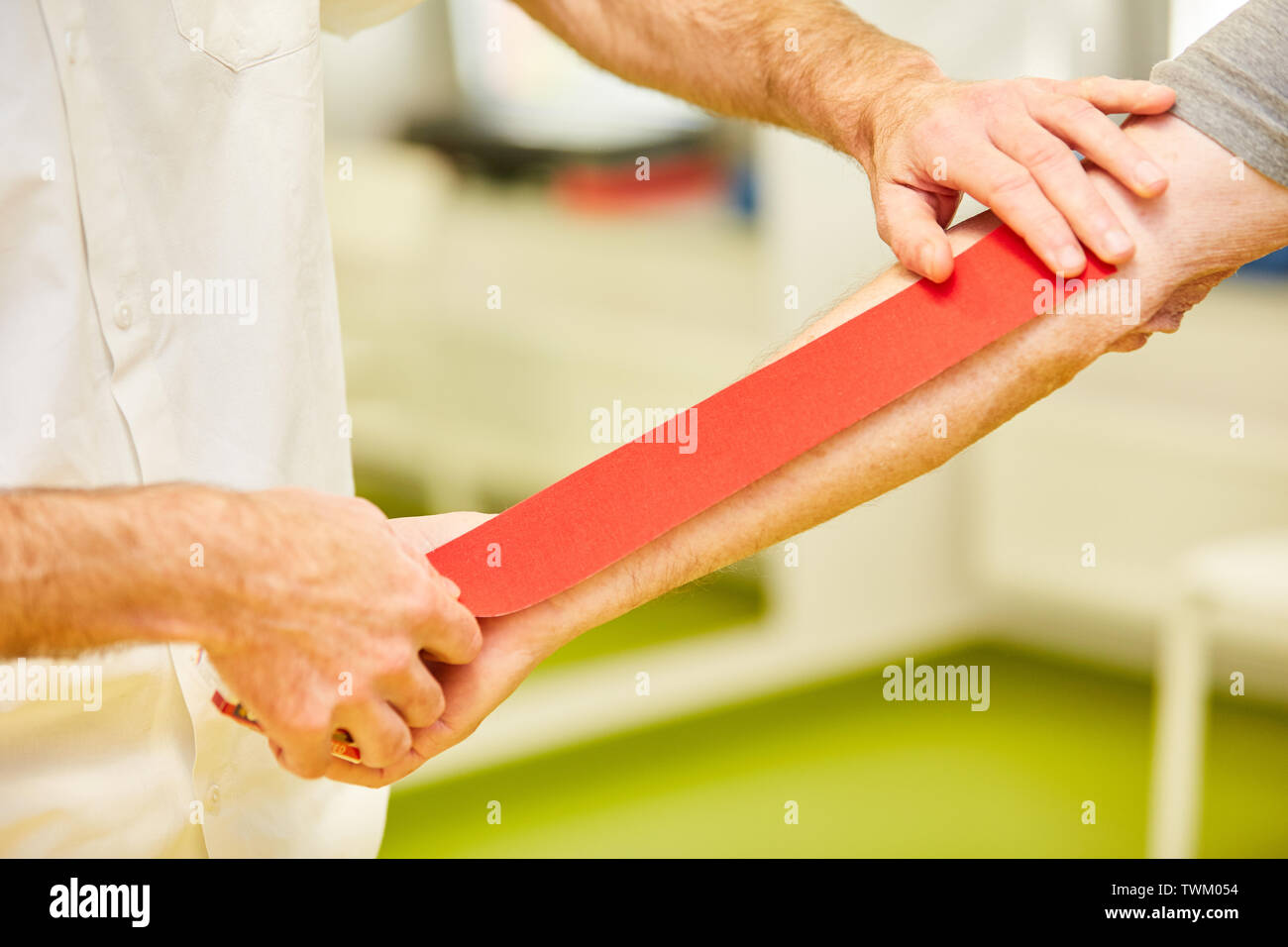 Naturopath attached Kinesio tape to the patient's forearm for pain