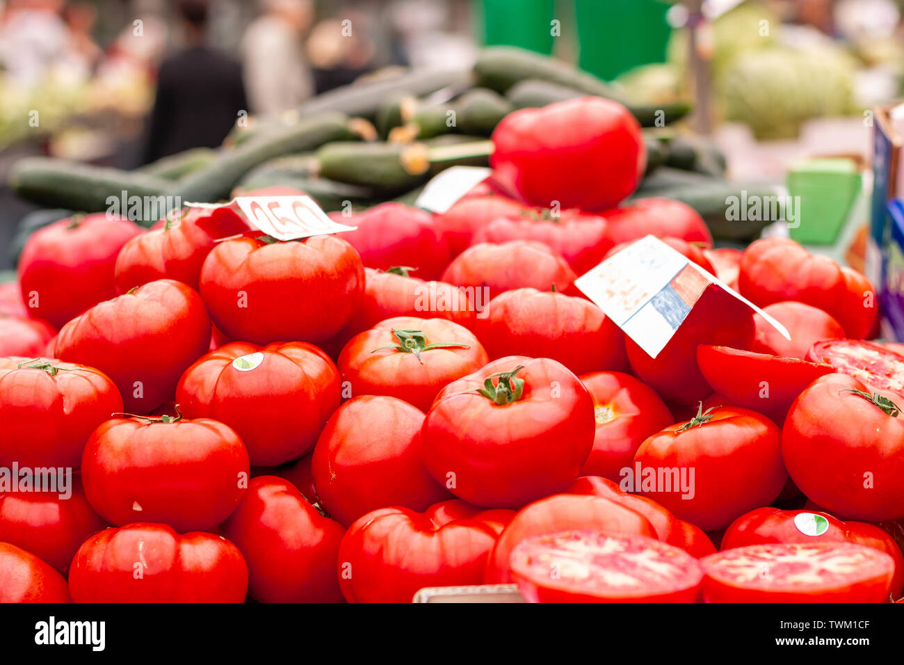 Pile of fresh red tomatoes ready for sale on the marketplace counter in ...