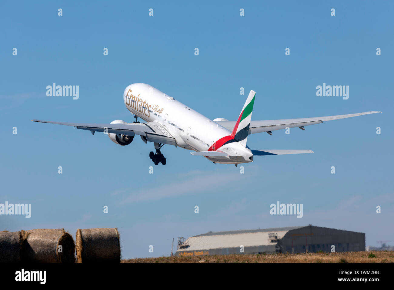 Emirates Boeing 777-31H/ER (REG: A6-EGE) taking off from runway 31, intersection Foxtrot, hence the late take-off. Stock Photo