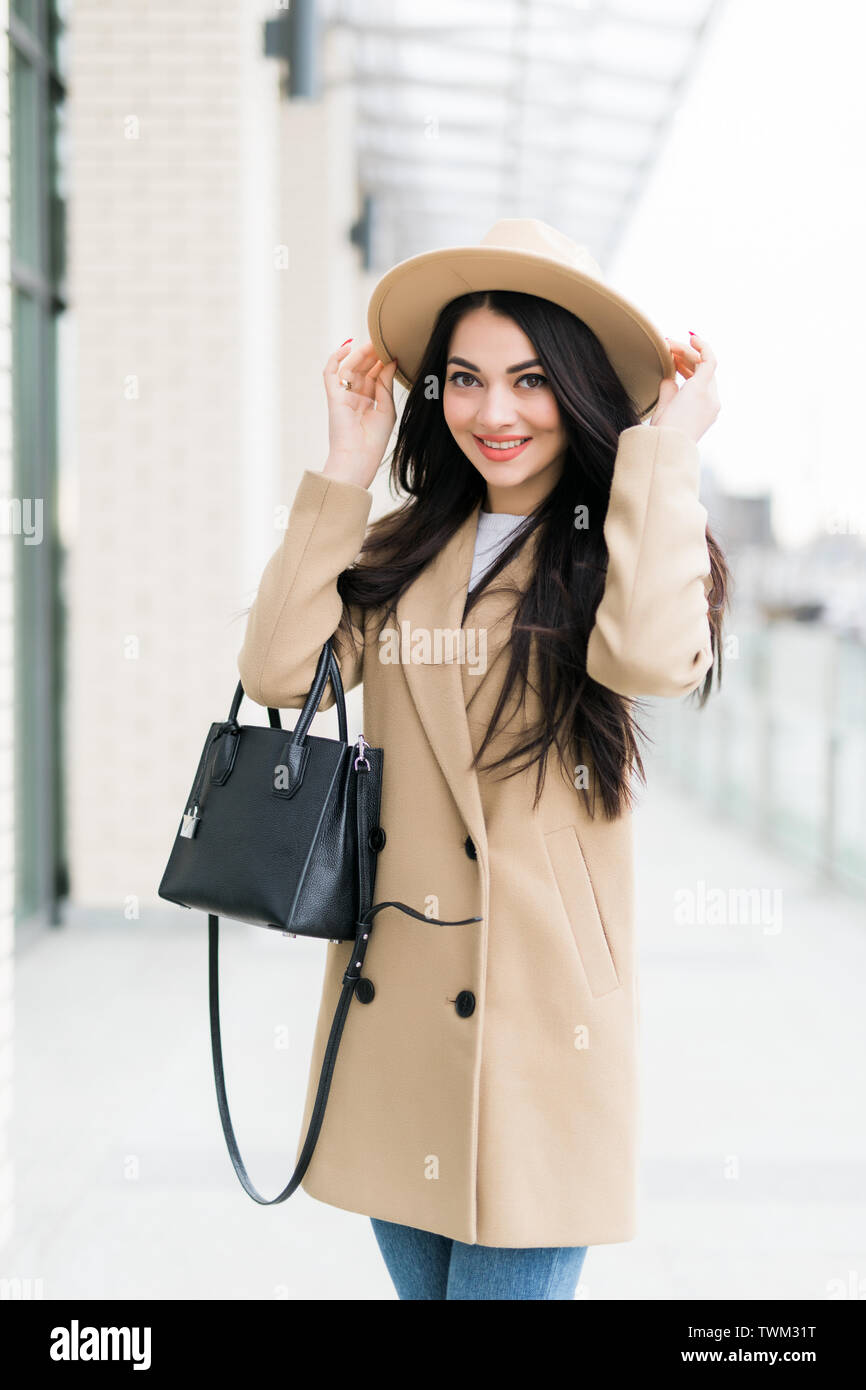 Pretty smiling brunette girl walking on the street Stock Photo - Alamy