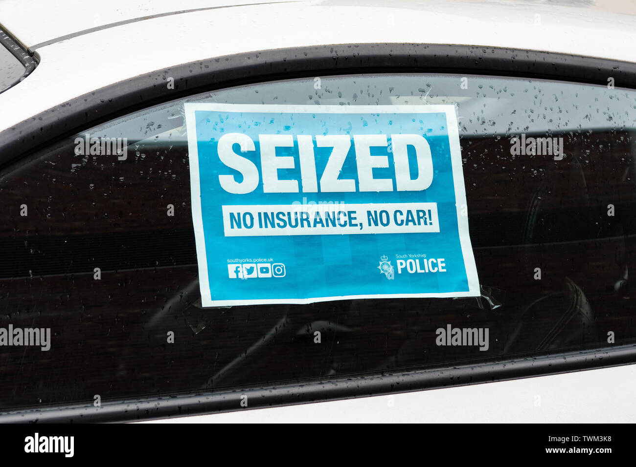 'Seized  No Insurance, No Car' sign on window of an uninsured car outside Barnsley police station that has been seized by South Yorkshire Police Stock Photo