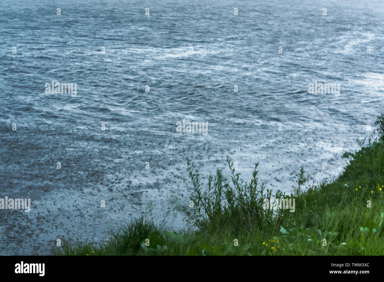 inclement weather with rain, heavy rain hits the water Stock Photo - Alamy