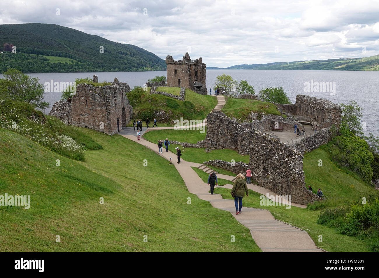 Drumnadrochit, Inverness, Scotland - June 10, 2019: Urquhart Castle ruins are shown next next to Loch Ness during an afternoon day. Stock Photo