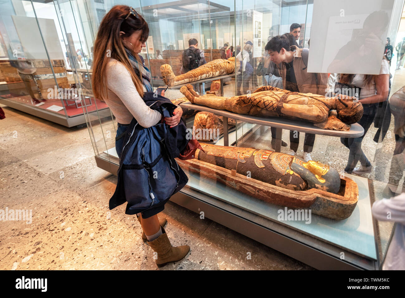London, United Kingdom - May 13, 2019: The British Museum, London. Hall of Ancient Egypt, tourist admiring ancient mummies exhibition .  Stock Photo