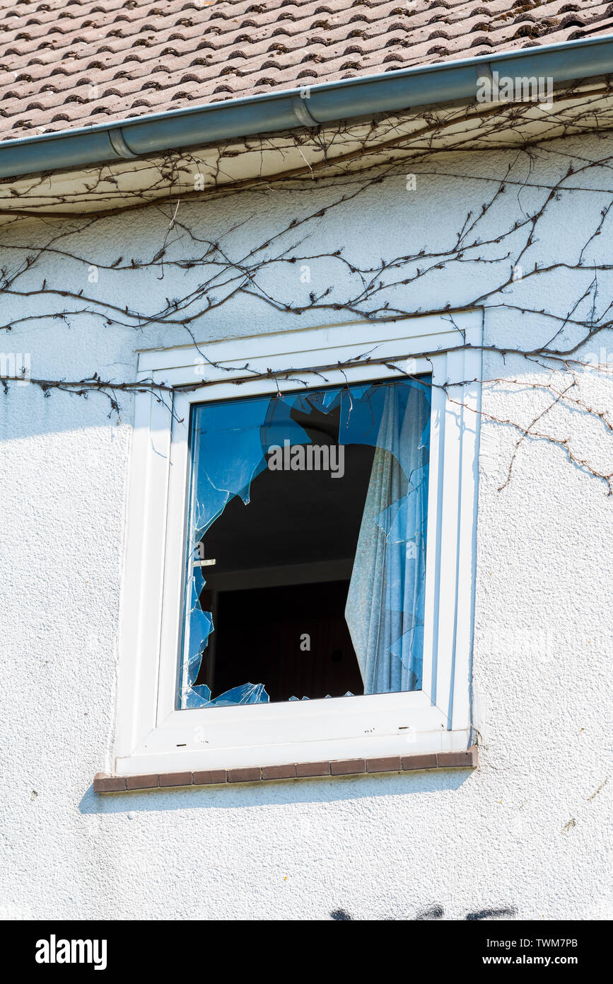 Broken window in a building. The concept of vandalism Stock Photo - Alamy