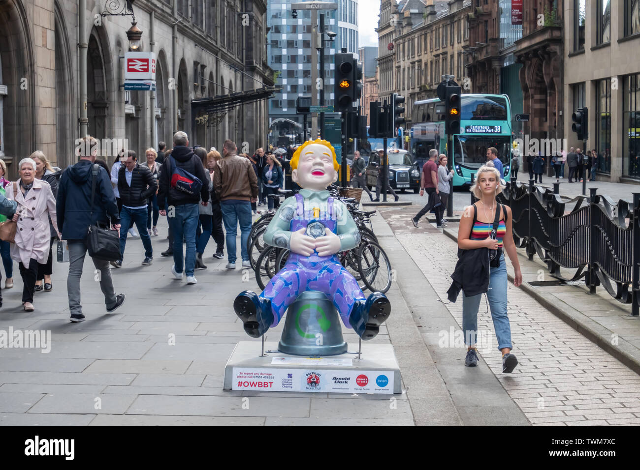 Glasgow, Scotland, UK. 21st June, 2019. Bring Back Your Empties, Wullie, created by Michelle C Cranwell. Oor Wullie has gathered up his empties and is heading to the shop to return them and collect his 20p pieces. This sculpture is inspired by Scotland’s forthcoming Deposit Return Scheme and is part of Oor Wullie’s BIG Bucket Trail. Credit: Skully/Alamy Live News Stock Photo