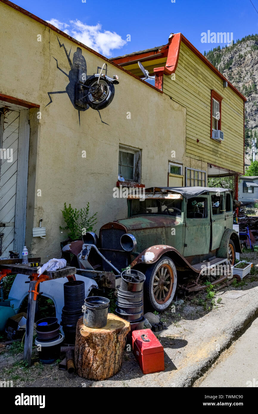 Old jalopy car outside junk store, Hedley, British Columbia, Canada Stock Photo