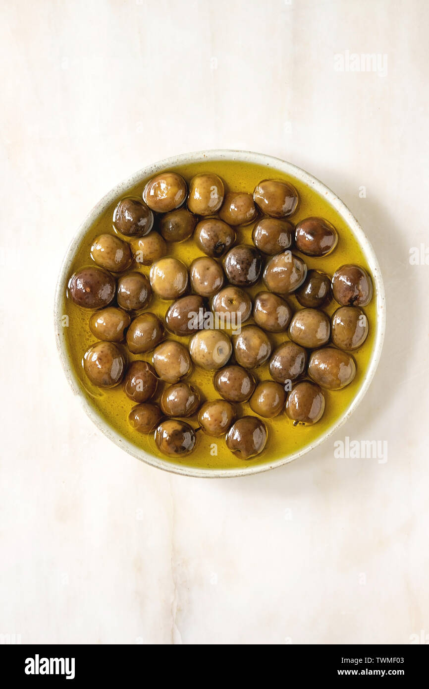 Green olives in olive oil Stock Photo Alamy