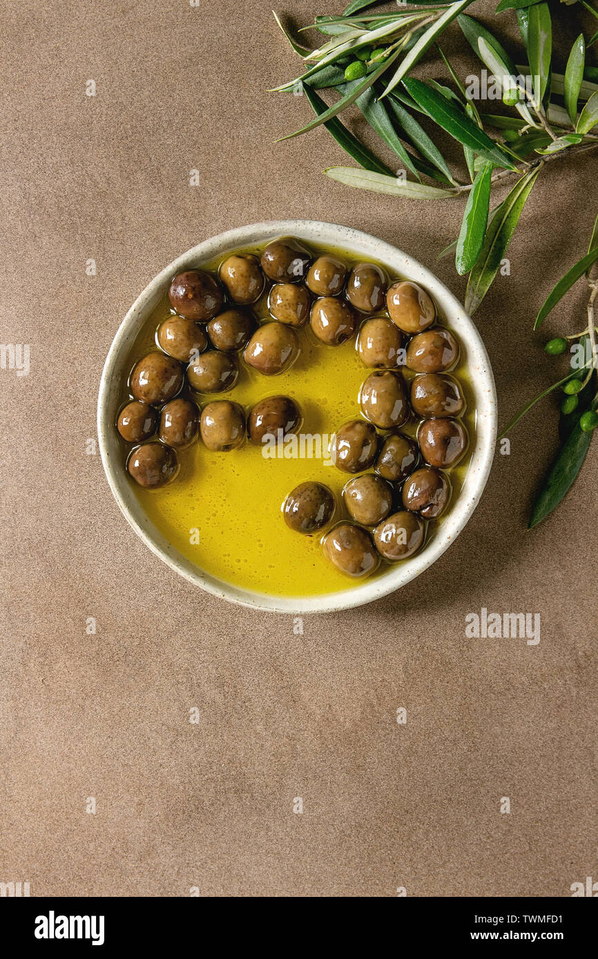 Green olives in olive oil Stock Photo Alamy
