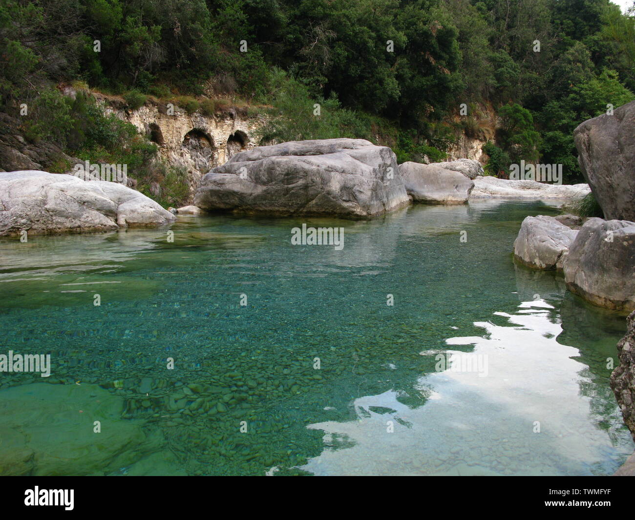 Blue river pool with ancient aqueduct behind Stock Photo - Alamy