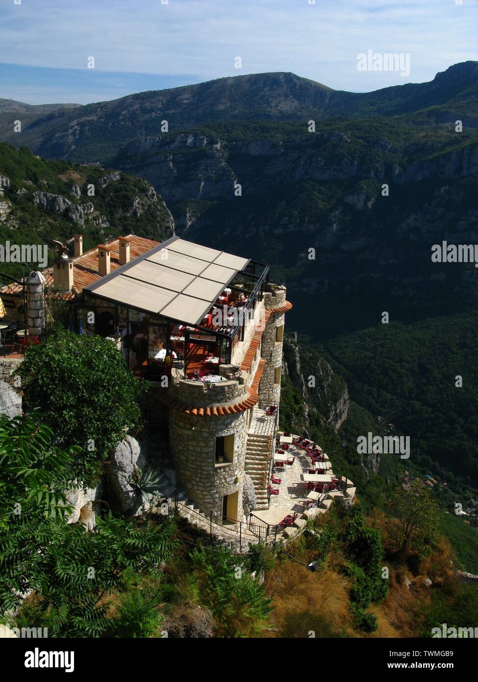Cliff top restaurant on the french riviera overlooking a green valley