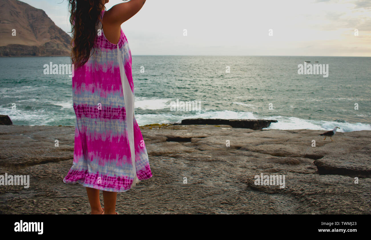 A woman with summer dress on the beach Stock Photo