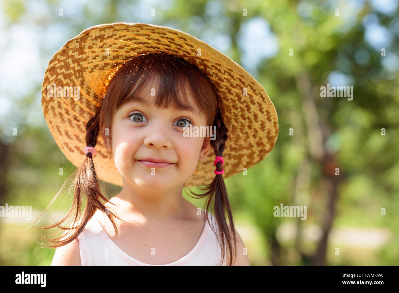 Portrait of surprised little girl in straw hat Stock Photo - Alamy