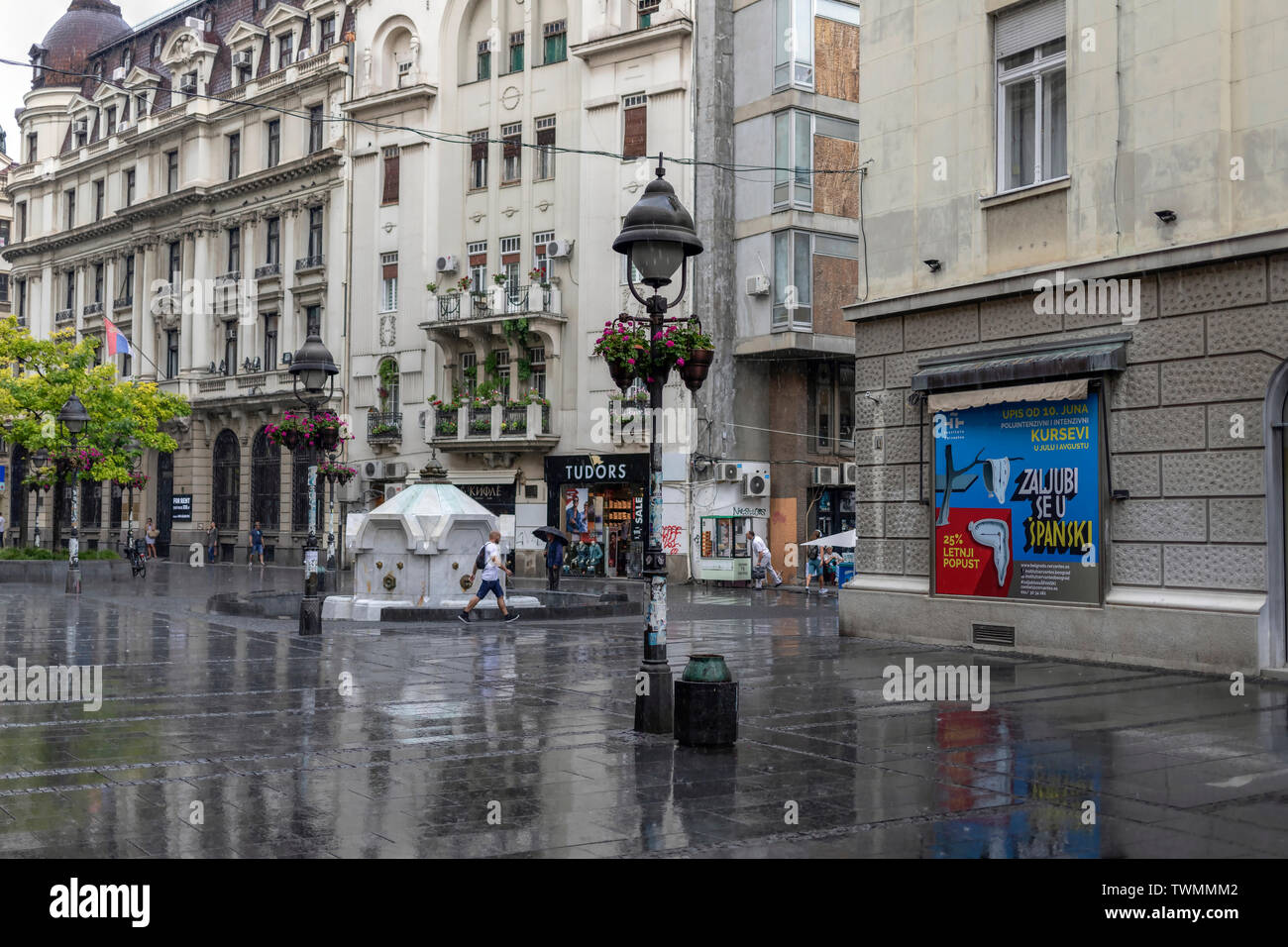 Belgrade, Serbia, June 18th 2019: Urban scene with people walking down the Knez Mihailova Street during the light rain Stock Photo