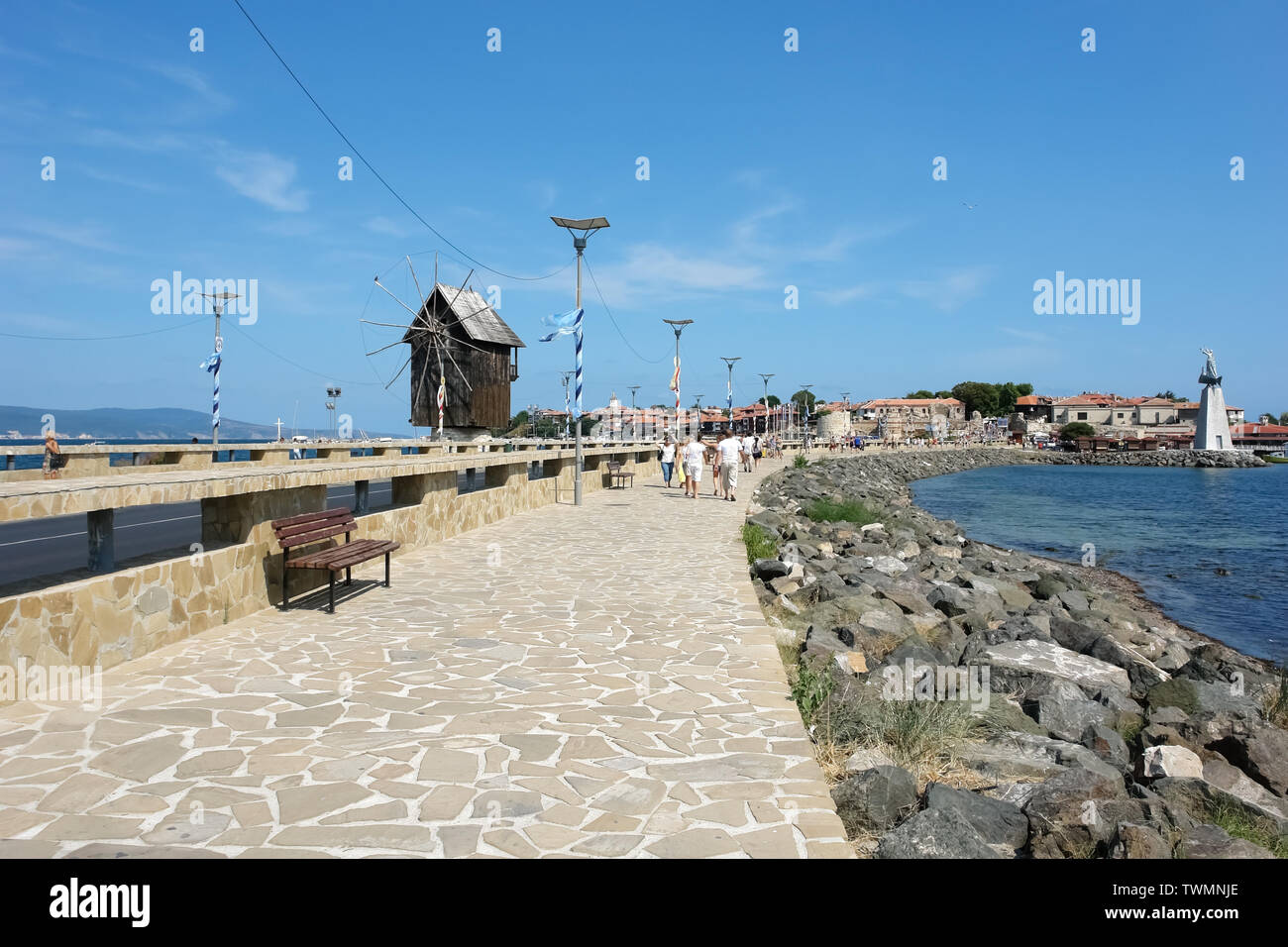 Nessebar, Bulgaria - August 17, 2012: View of the embankment with wooden windmill and harbor of the old town of Nessebar, Black Sea coast of Bulgaria. Stock Photo