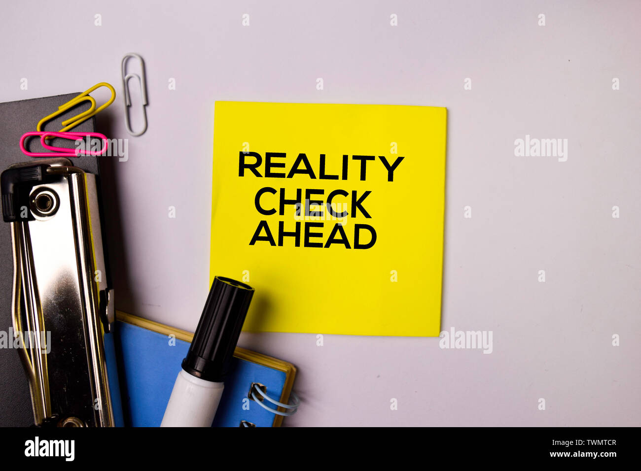 Reality Check Ahead on sticky notes isolated on white background. Stock Photo
