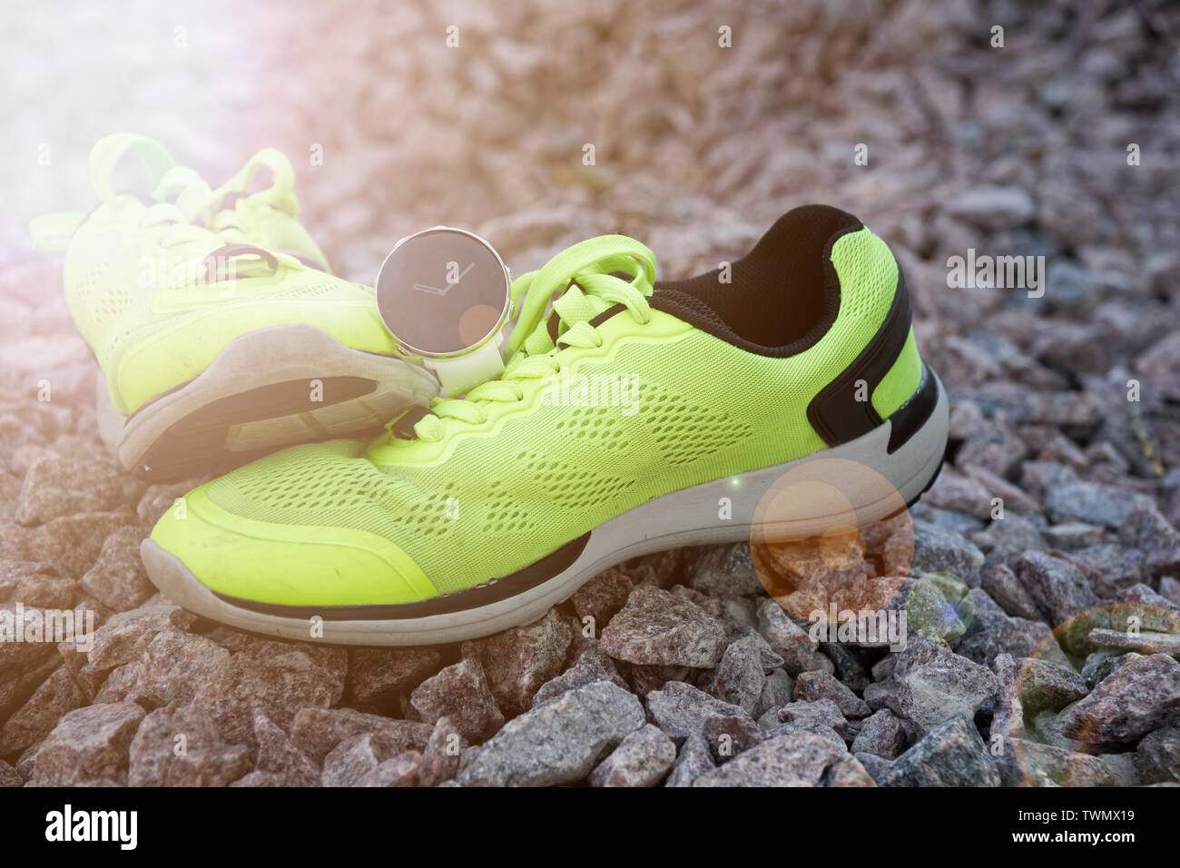 Sport watch for crossfit and triathlon on the yellow running shoes