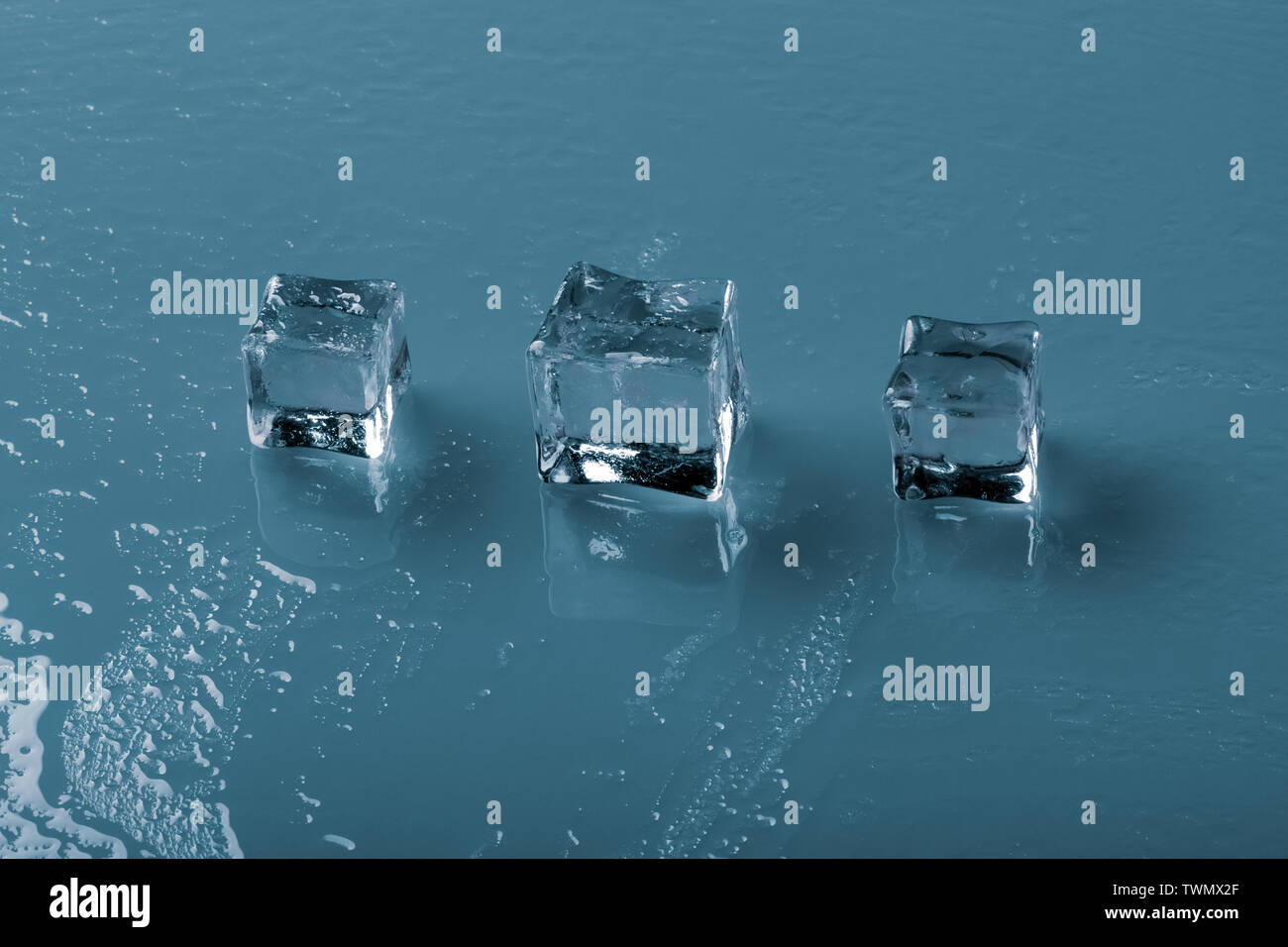 Set of crystal clear ice cubes over blue background Stock Photo - Alamy