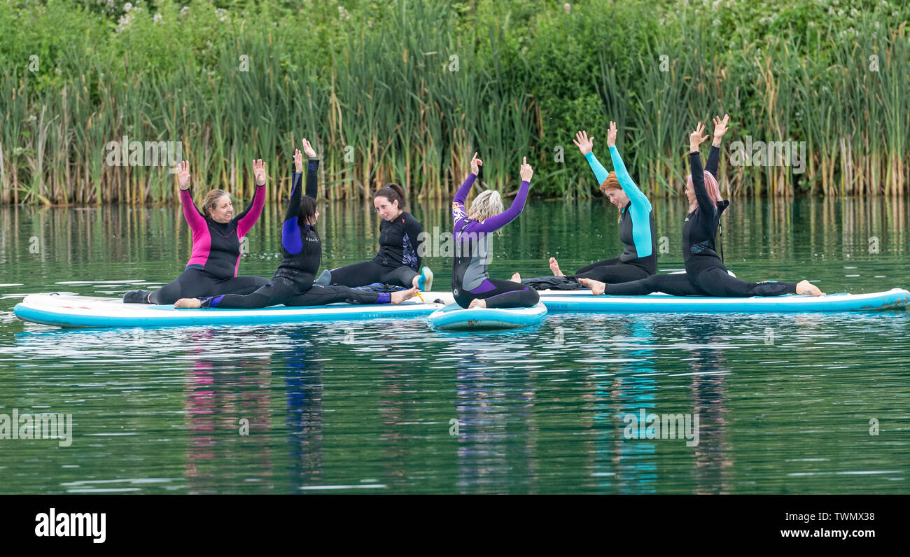 Upminster, Essex, UK. 21st June 2019. A new wellness initiative was launched today by Yogactive: Stand up Paddleboard Vinyasa yoga held at Stubbers Adventure Centre Upminster Essex Credit Ian Davidson/Alamy Live News Stock Photo