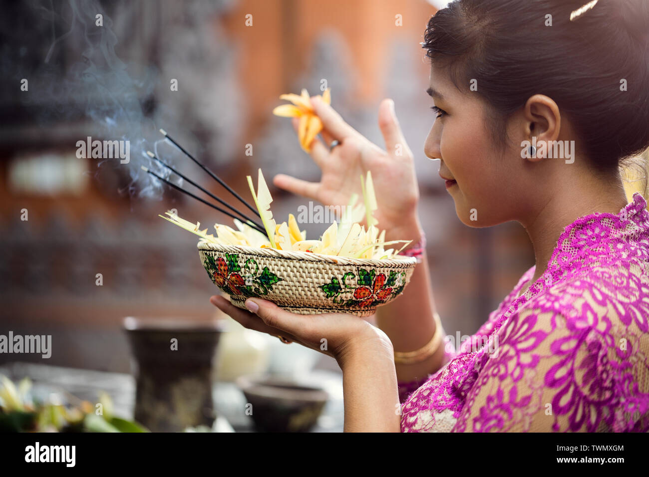Asian woman offers flowers to gods Stock Photo Alamy