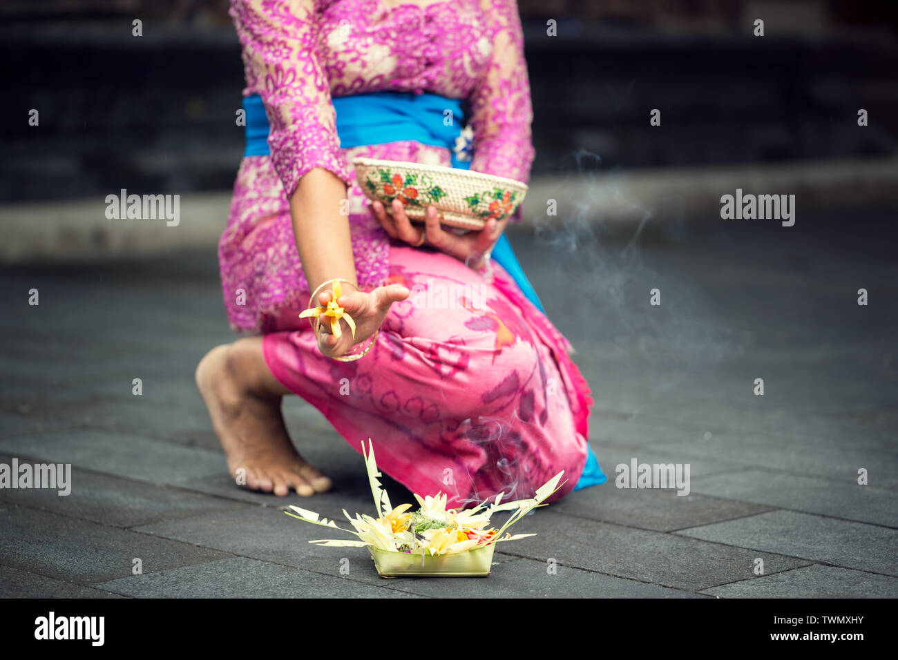 woman in traditional ceremonial clothing with offering for gods Stock
