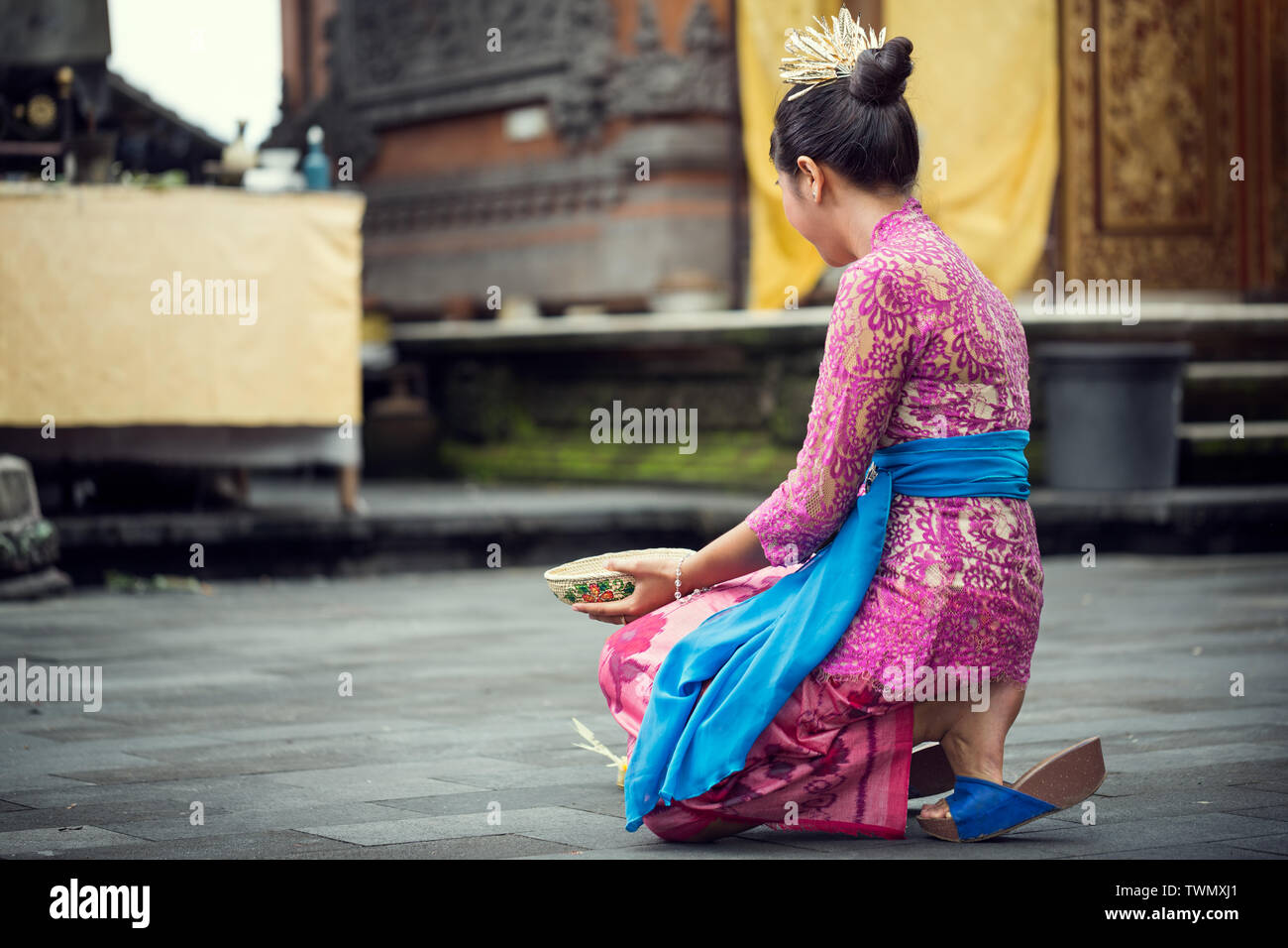 young Balinese woman to praying in Hindu temple Stock Photo