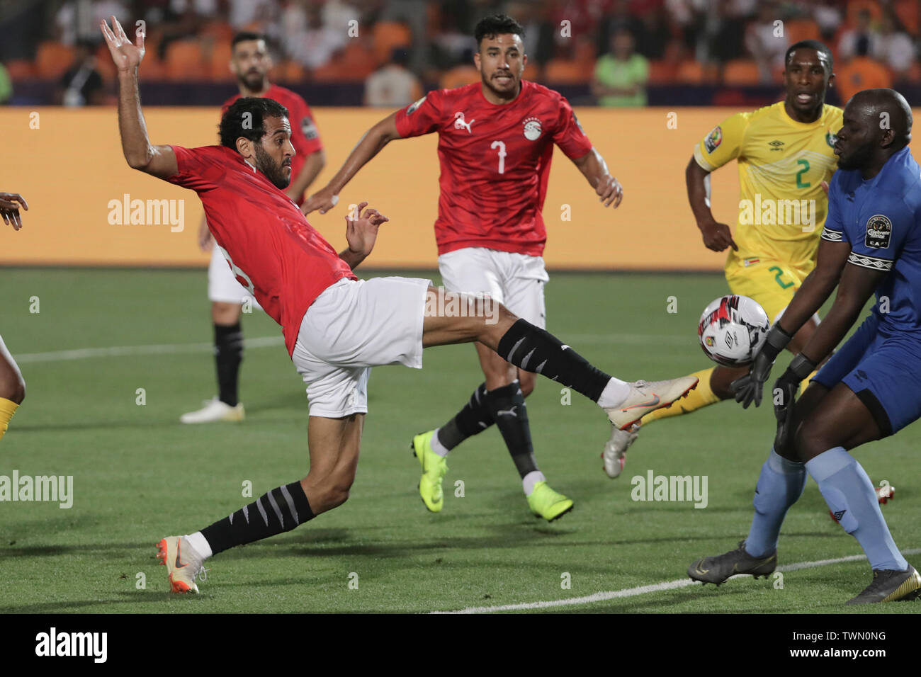 Cairo, Egypt. 21st June, 2019. Zimbabwe goalkeeper Edmore Sibanda (R) saves from Egypt's Marwan Mohsen (L) before they collide during the 2019 Africa Cup of Nations Group A soccer match between Egypt and Zimbabwe at the Cairo International Stadium. Credit: Oliver Weiken/dpa/Alamy Live News Stock Photo