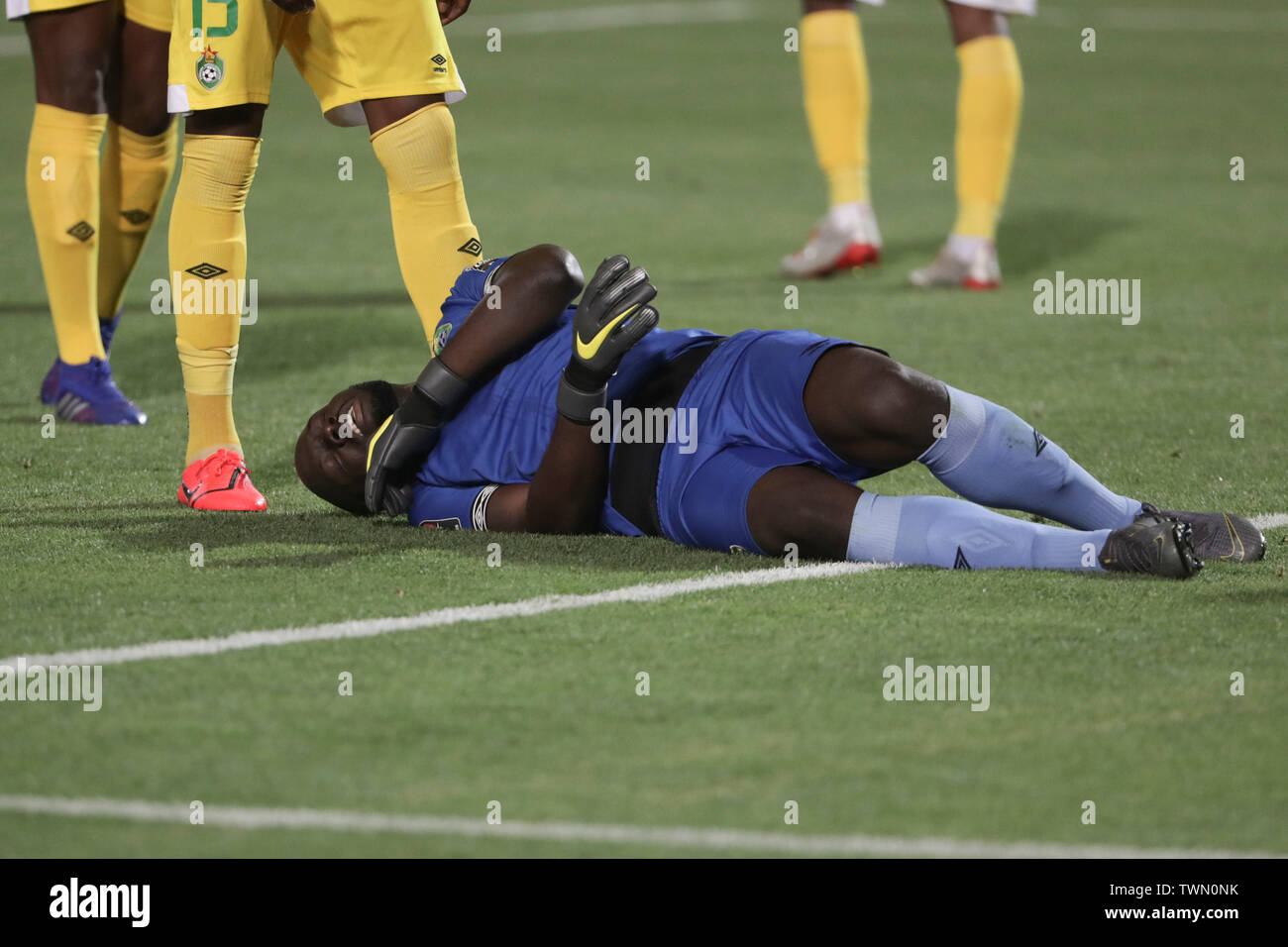 Cairo, Egypt. 21st June, 2019. Zimbabwe goalkeeper Edmore Sibanda lies injured on the ground during the 2019 Africa Cup of Nations Group A soccer match between Egypt and Zimbabwe at the Cairo International Stadium. Credit: Oliver Weiken/dpa/Alamy Live News Stock Photo
