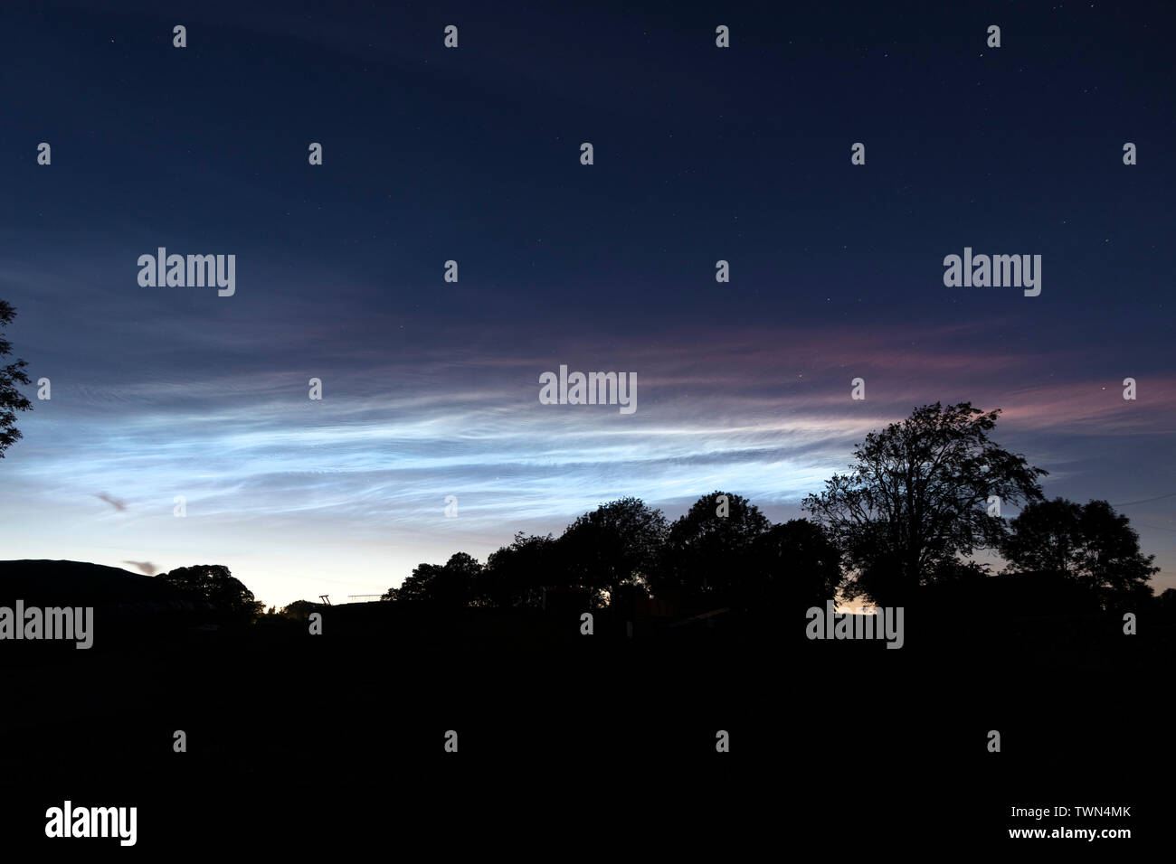 Teesdale, County Durham, UK.  22nd June 2019. UK Weather.  Beautiful noctilucent clouds light up the sky above Teesdale in North East England. These rare luminous clouds form due to ice crystals in the Earth's upper atmosphere and are only visible during astronomical twilight in the summer months. Credit: David Forster/Alamy Live News Stock Photo