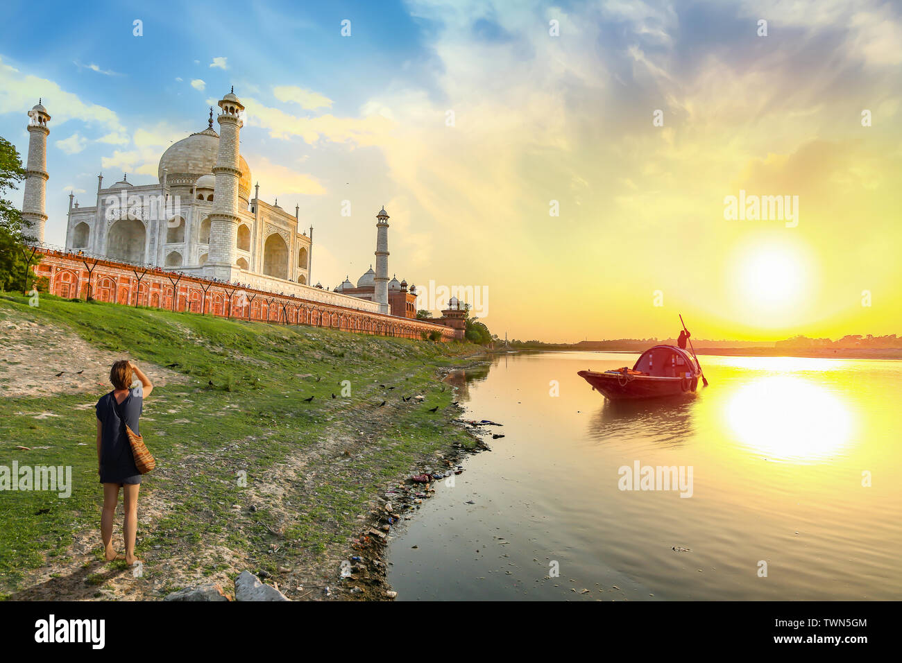 Taj Mahal at sunset with view of boat on river Yamuna at Agra India. Taj Mahal is a UNESCO World Heritage site and mughal architecture masterpiece Stock Photo
