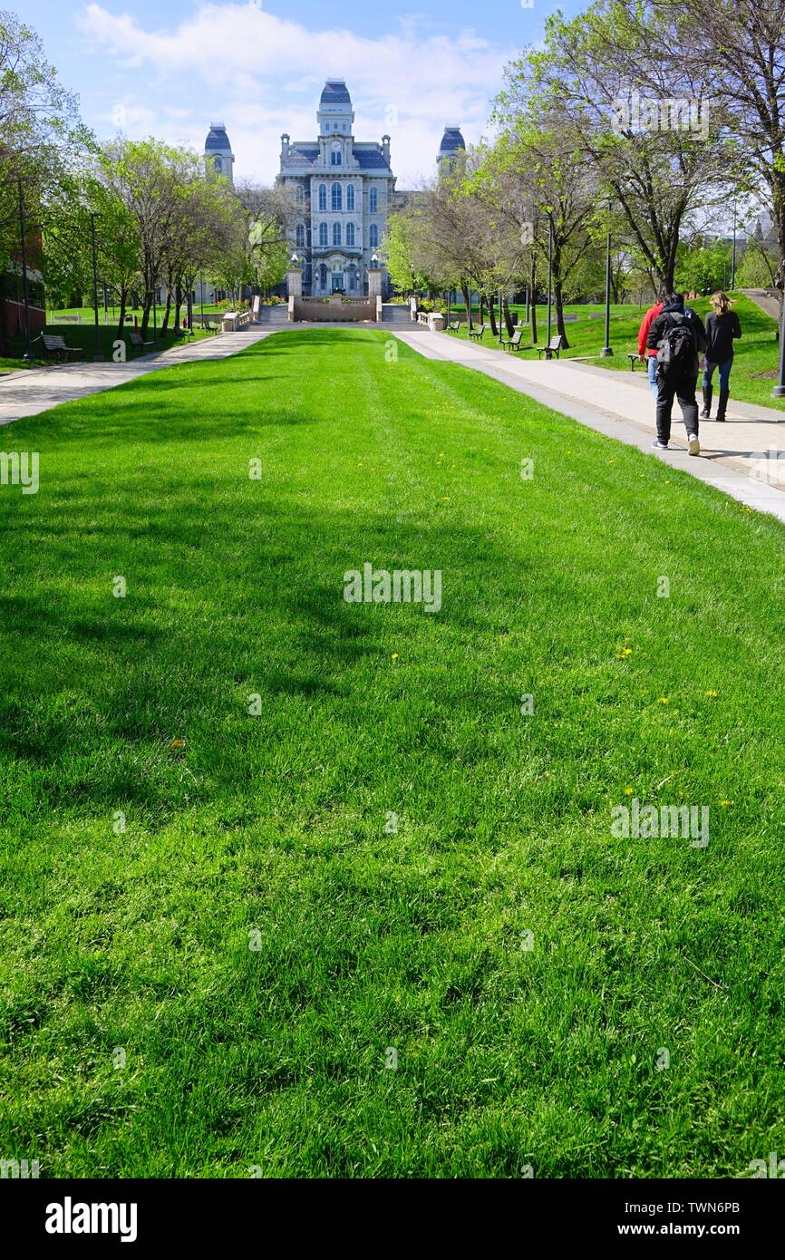 Lush green lawn separates walkways leading to the Hall of Languages, home of the College of Arts and Sciences, the  oldest building in Syracuse Univer Stock Photo