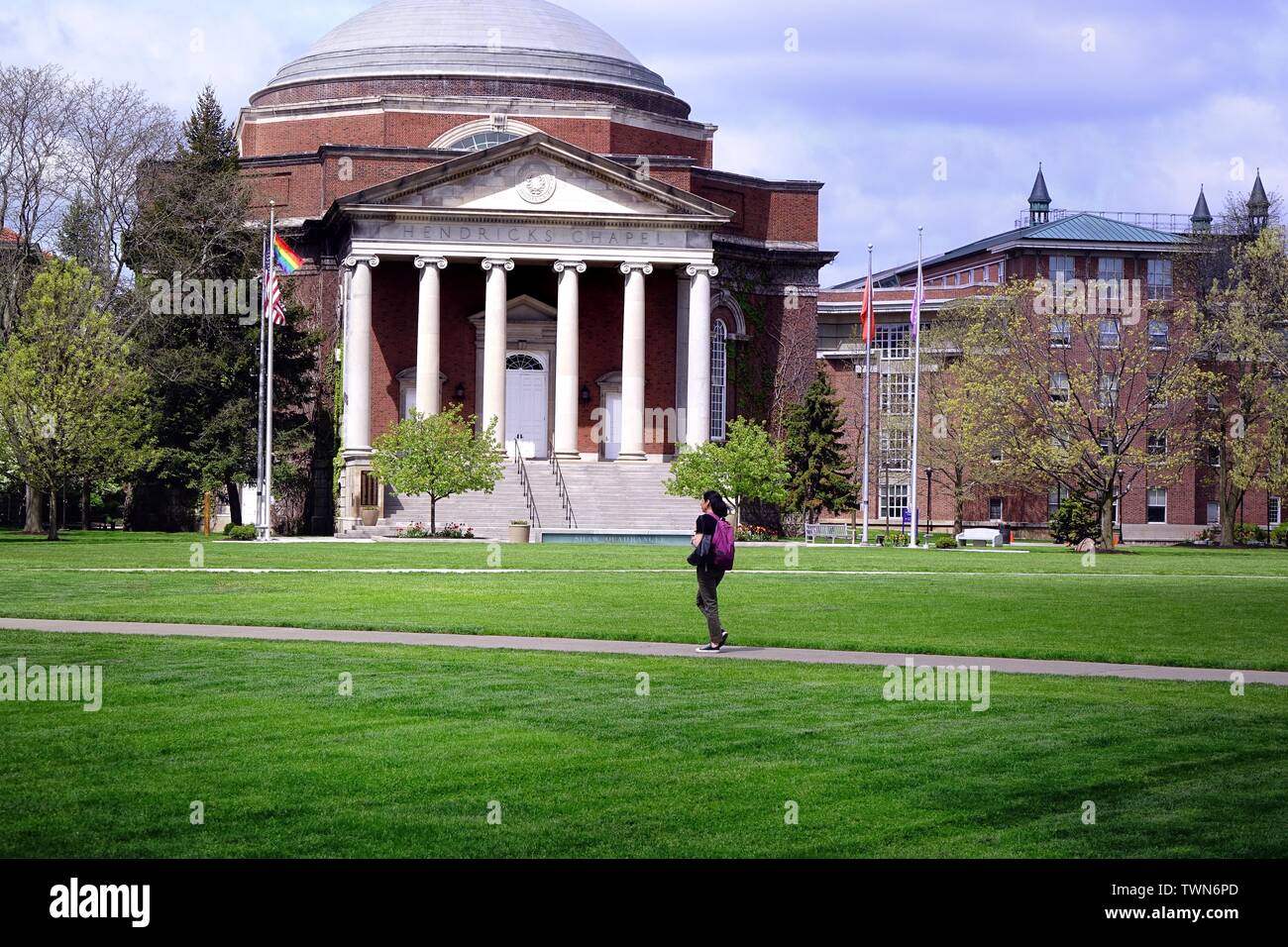 A student walks across the quad in front of Hendricks Chapel at Syracuse University. Stock Photo