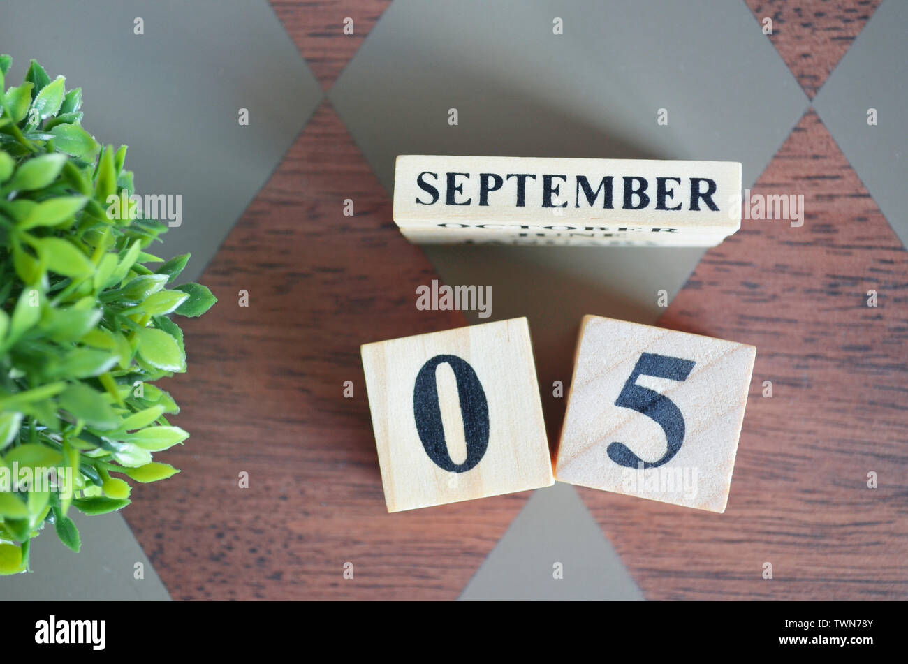 Date of September with leaf on diamond pattern table for background ...